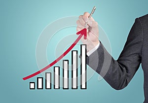 Business man drawing a growing graph