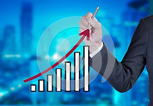 Business man drawing a growing graph