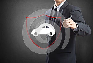 Business man drawing shield protecting auto car