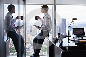 Business Man Drinking Coffe And Reading News On Tablet