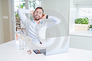 Business man eating take away asian noodles food while working using computer laptop and smiling