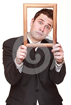 Business man with empty frame facial expression