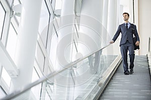 Business man on escalator