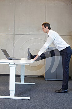 Business man exercises in office