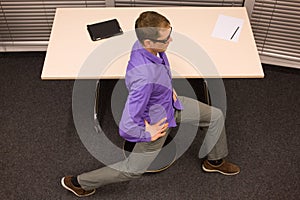 Business man exercising at desk at workplace