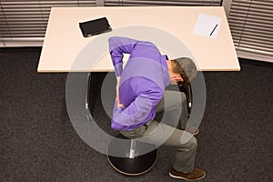 Business man exercising at desk at workplace