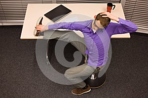 Business man exercising at desk at workplace