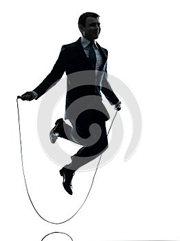 Business man exercising jumping rope silhouette