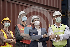 Business man and  Factory workers wearing in a medical mask and safety cloth at outdoor factory cargo warehouse