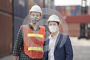 Business man and  Factory workers wearing in a medical mask and safety cloth at outdoor factory cargo warehouse
