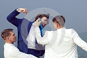 Business man fighting. Businessman punching, hitting colleague, twin men in formal outfit.