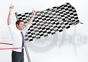 Business man at finish line against white skyline and checkered flag