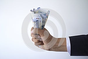 Business man fist holding 100 soles bills, peruvian currency concept