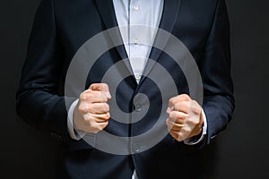 Business man fists clenched in anger. Annoying emotions at work