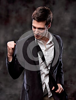 business man with fists clenched in victory.