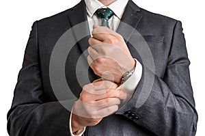 Business man fixing his cufflinks
