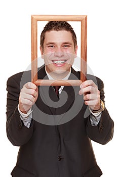 Business man framing his face with wood frame