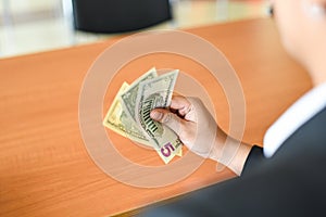 Business man giving banknotes and money cash in hand - businessman holding money rich credit with success concept