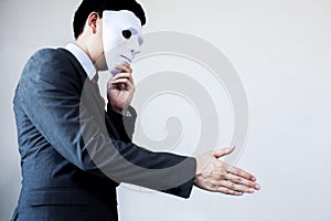 Business man giving dishonest handshake hiding in the mask - Bus photo