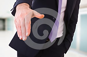 Business man giving hand.