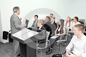 Business man giving presentation to his Colleagues