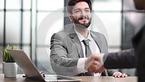 business man greets the employee with a handshake,