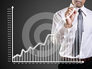 Business man hand drawing a graph