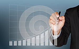 Business man hand drawing a growing graph