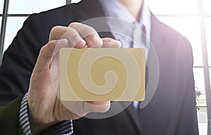 Business man hand holding blank business card showing