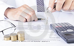 Business man with hand holding key and calculator and coins stack for finance cosulting ideas concept backgrounds