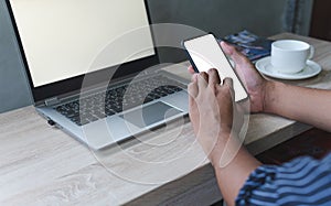 Business man hand holding smart mobile phone, using credit card for online shopping