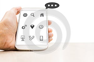Business man in hand holding a smartphone with social media icon technology concept