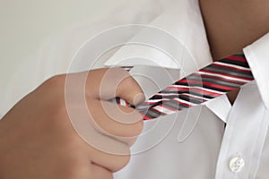 Business man hand holding a tie