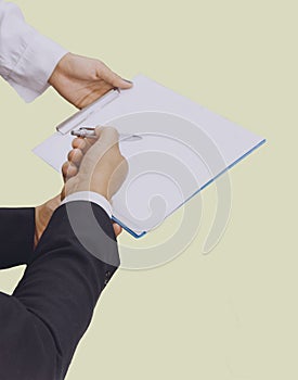 Business man hand with pen point on paper,Asian women and men are doing business in the office