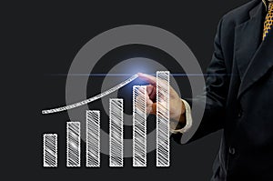 Business man hand is pointing or pressing graph plan the growth financial icon symbol on virtual screen. Business Investment