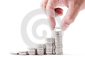 Business man hand put coin to cion stacked isolated