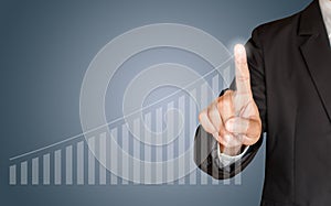 Business man hand touching a graph on blue background