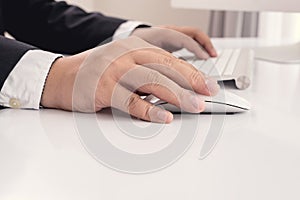 Business man hand using computer mouse
