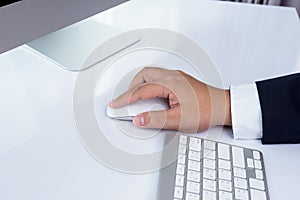 Business man hand using computer mouse