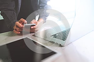 business man hand working on computer laptop computer and digital tablet and smart phone on marble desk as concept