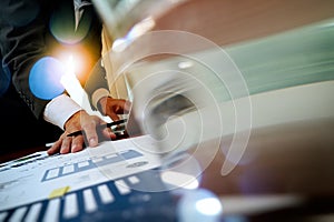 Business man hand working on laptop computer with business graph