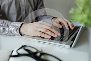 Business man hands busy typing laptop at office desk