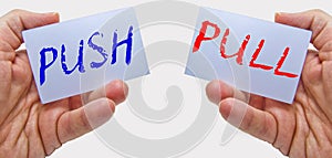 Business man hands handling cards with push pull words photo
