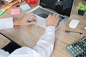 Business man hands holding a credit card and using laptop