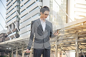 Business Man hands holding mobile phone outdoor surfing internet online technology lifestyle in city street. Entrepreneur young