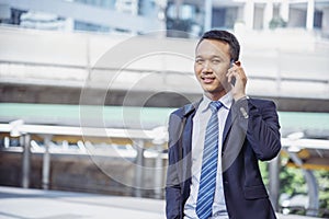 Business Man hands holding mobile phone outdoor surfing internet online technology lifestyle in city street. Entrepreneur young