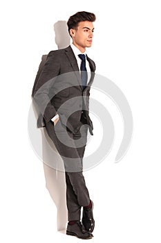 Business man with hands in pockets and legs crossed