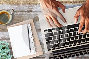 Business man hands using a laptop on workplace