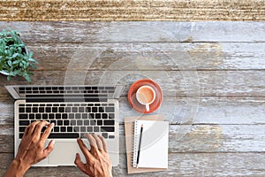 Business man hands using a laptop on workplace