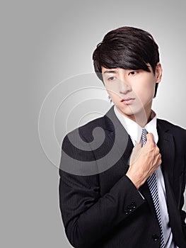 Business man having stress and touch his tie